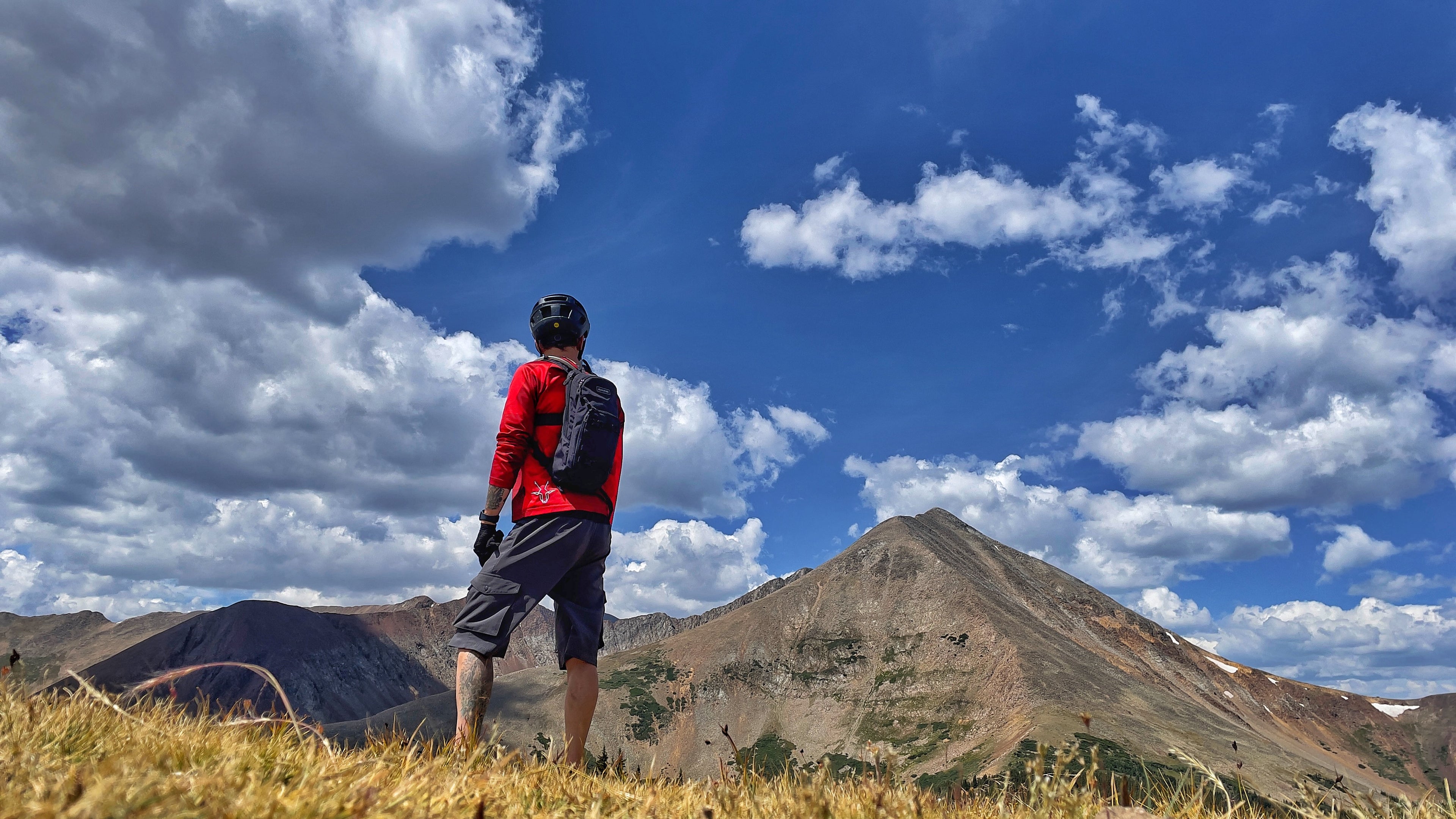 Justin standing atop Georgia Pass in the North Table Mountain Jersey